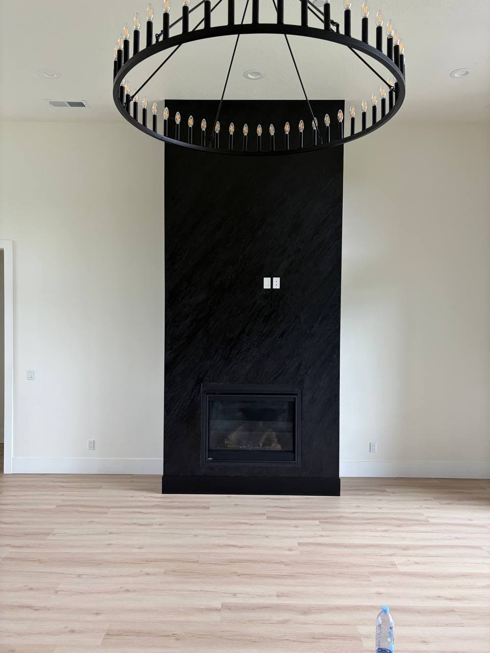 Frontal view of the dark, hand-troweled custom fireplace, Hubbard OR