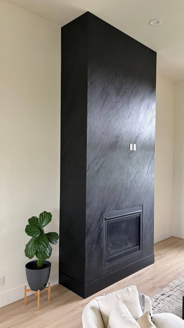 Stunning custom black rock textured fireplace finish in a modern living room, Hubbard OR