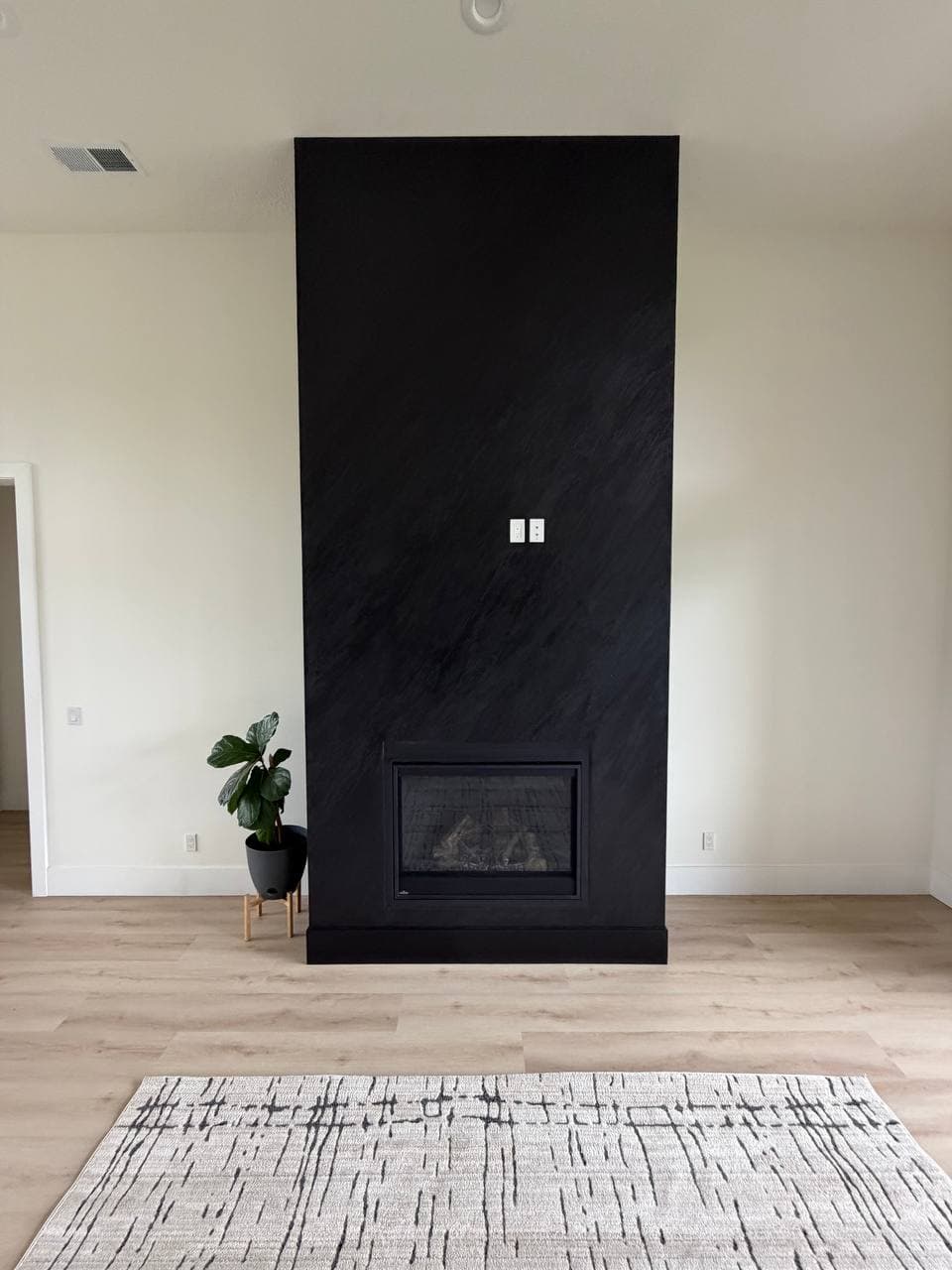 Striking black rock textured fireplace taking center stage in the living room, Hubbard OR